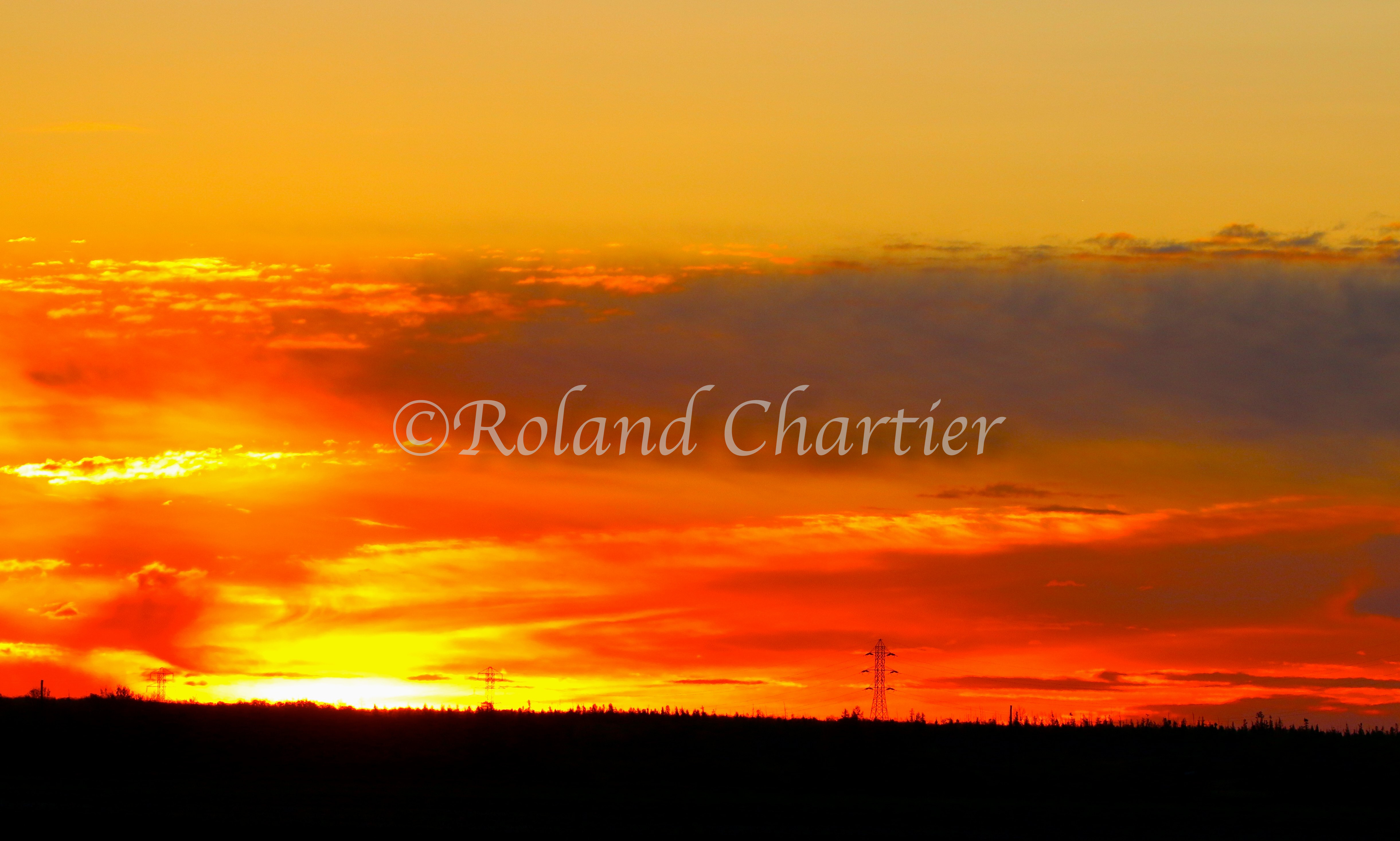 An orange sunset over a prairie landscape